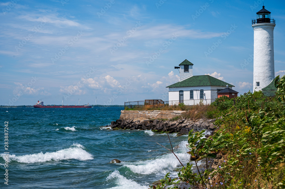 A windwhipped lightouse stands guard over Lake Ontario