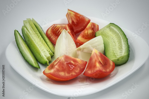 tomato and cucumber on white plate