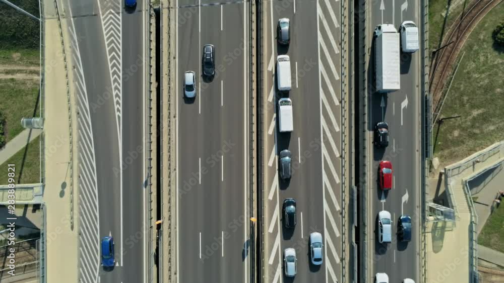 Transportation and Infrastructure: Highway Interchange and Junction with Cars, Trucks and Buses. Aerial View of Road Traffic Jam at Daytime Rush hour in Warsaw, Poland. 4K Close Up Fly Over shot Transportation and Infrastructure: Highway Interchange and Junction with Cars, Trucks and Buses. Aerial View of Road Traffic Jam at Daytime Rush hour in Warsaw, Poland. 4K Close Up Fly Over shot