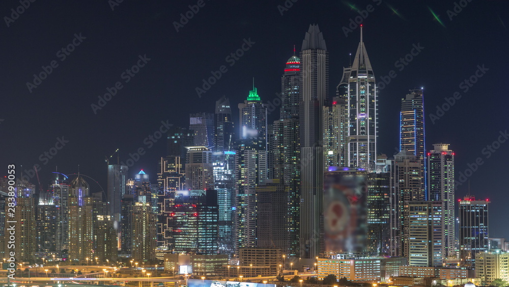 Fototapeta premium Dubai Marina skyscrapers and golf course night timelapse, Dubai, United Arab Emirates