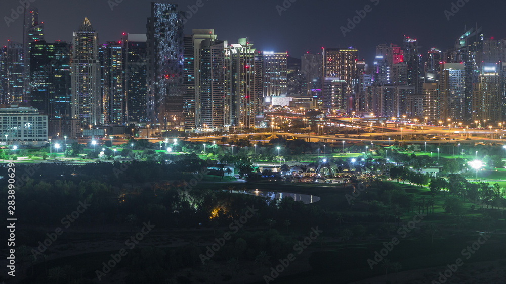 Jumeirah lake towers and Dubai marina skyscrapers and golf course night timelapse, Dubai, United Arab Emirates Jumeirah lake towers and Dubai marina skyscrapers and golf course night timelapse, Dubai, United Arab Emirates