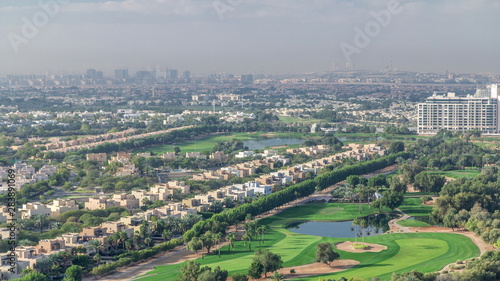 Aerial view to villas and houses with Golf course with green lawn and lakes timelapse