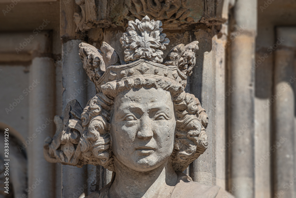 Wall figure of the queen at main facade of catholic cathedral in Magdeburg, Germany, closeup, details