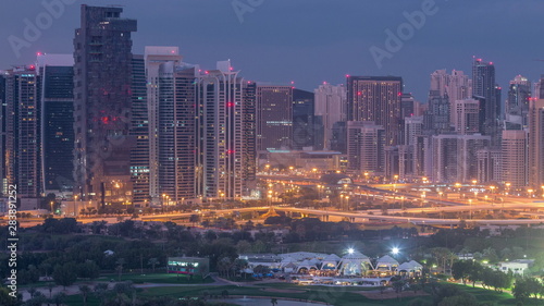 Jumeirah lake towers and Dubai marina skyscrapers and golf course night to day timelapse, Dubai, United Arab Emirates