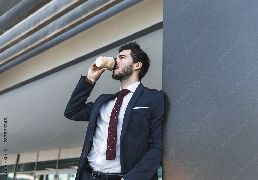 Side view man in suit drinking coffee Side view man in suit drinking coffee