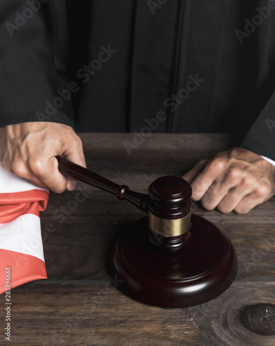 Close-up judge striking wooden gavel