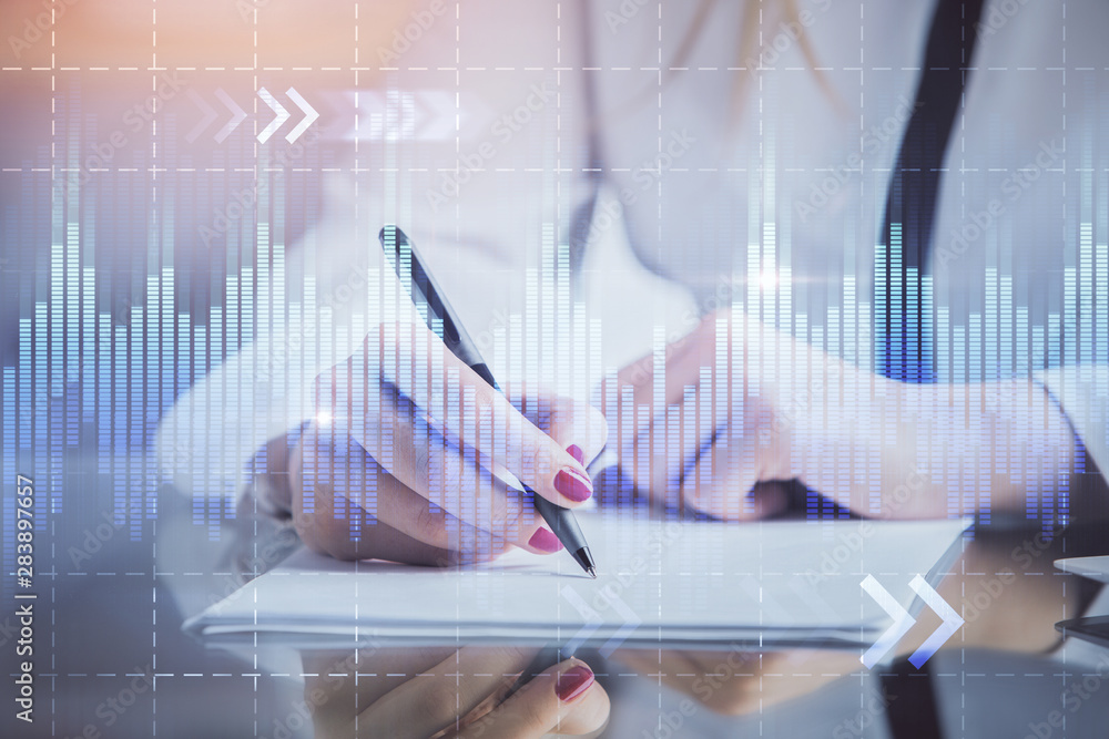 Double exposure of hands making notes with forex chart huds. Stock market concept. Double exposure of hands making notes with forex chart huds. Stock market concept.