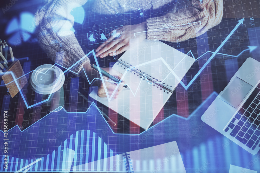 Forex graph on hand taking notes background. Concept of research. Double exposure Forex graph on hand taking notes background. Concept of research. Double exposure
