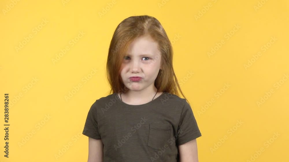 Little girl showing emotion punishment, compositing on yellow background. Slow motion Little girl showing emotion punishment, compositing on yellow background. Slow motion