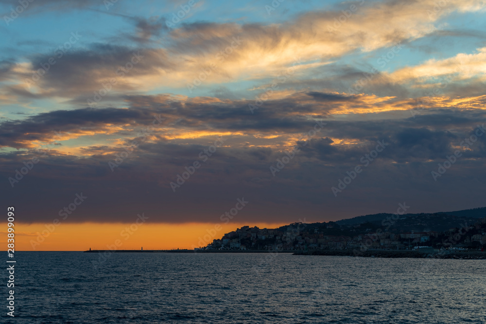 Clouds of contrasting color over the evening city