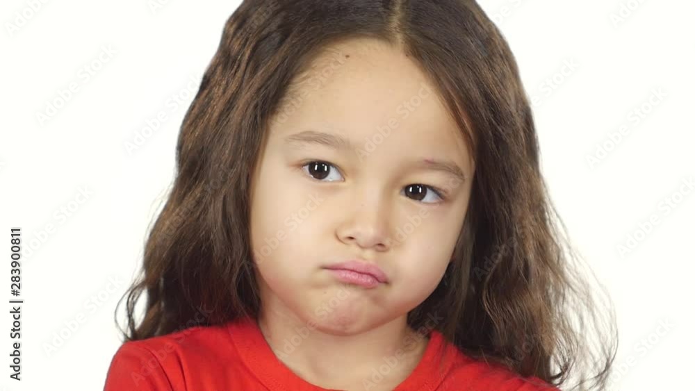 Close-up of little female crosses hands posing at white background. Slow motion Close-up of little female crosses hands posing at white background. Slow motion