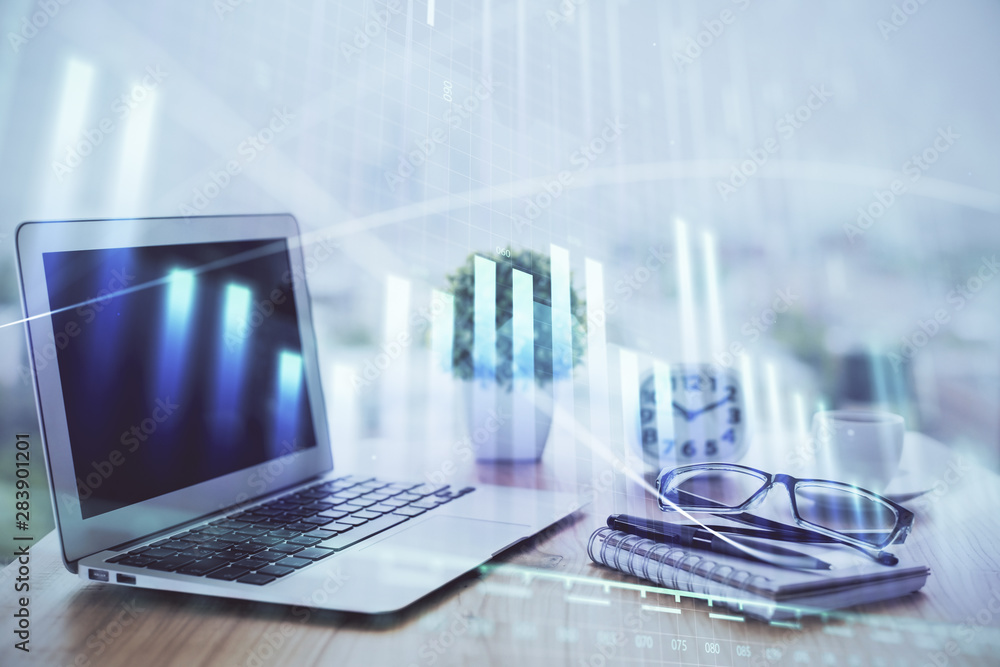 Forex graph hologram on table with computer background. Multi exposure. Concept of financial markets. Forex graph hologram on table with computer background. Multi exposure. Concept of financial markets.