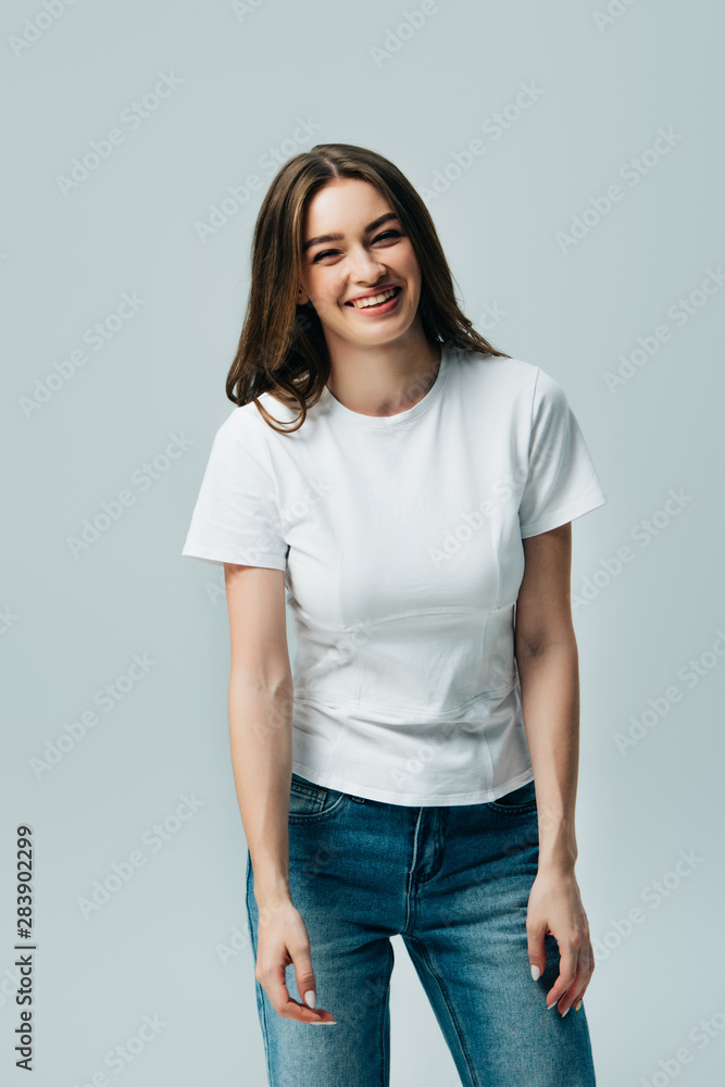 happy laughing beautiful girl in white t-shirt isolated on grey happy laughing beautiful girl in white t-shirt isolated on grey