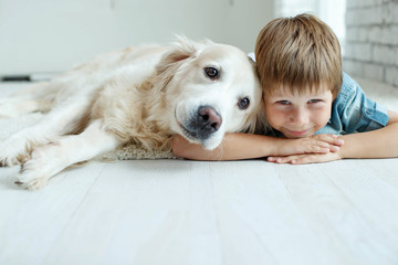 A child with a dog. Little boy with a dog at home. 