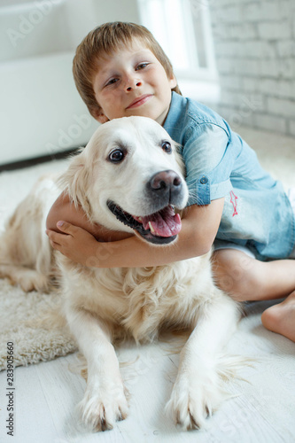 A child with a dog. Little boy with a dog at home. 