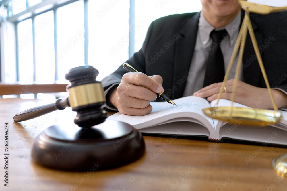 Judge or lawyer have gavel with balance work in office Judge or lawyer have gavel with balance work in office