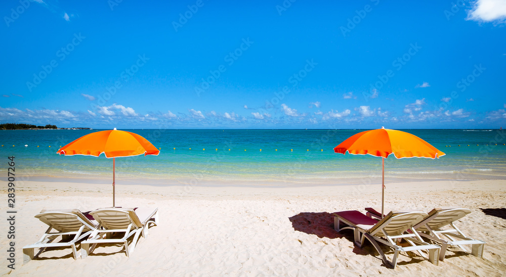 Parasols and sand beach in Mauritius island