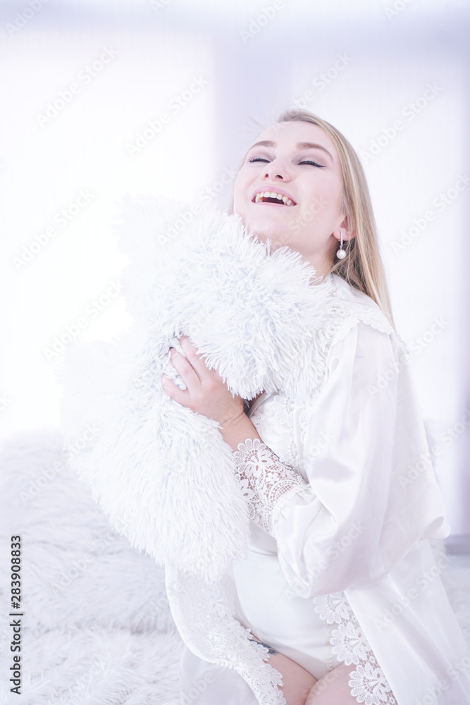 Young woman want to sleep and sit on white windowsill alone in lingerie Young woman want to sleep and sit on white windowsill alone in lingerie