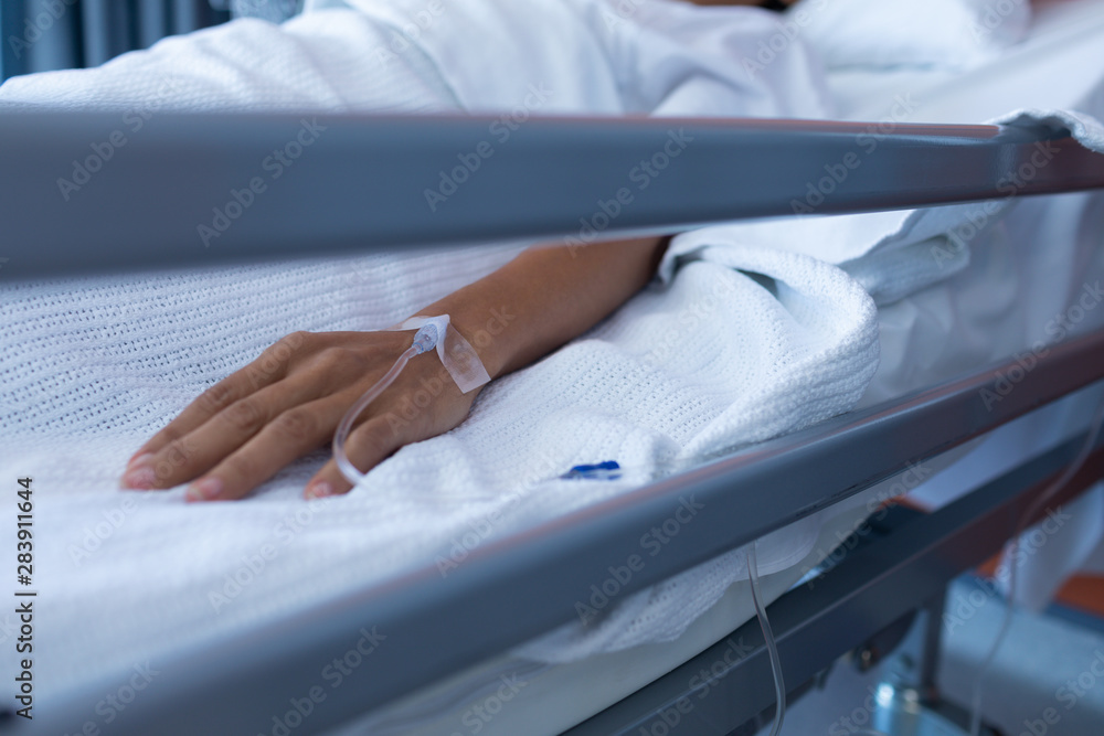 Fototapeta premium Female patient lying on bed in the ward at hospital