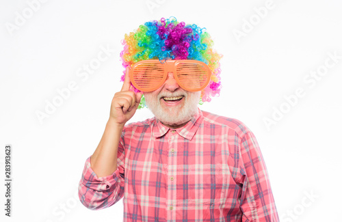 So much fun. happy birthday. corporate party. mature bearded man in colorful wig and party glasses. Crazy man in playful mood. anniversary holiday. happy man with beard. Celebration retirement