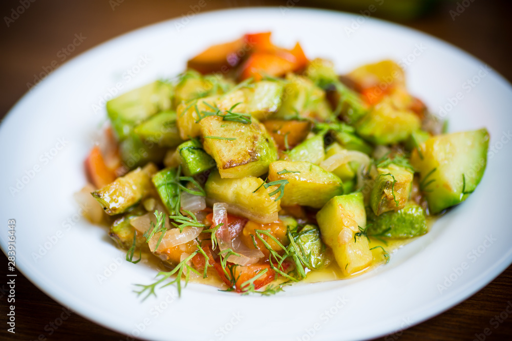 fried zucchini with red pepper, onions, tomatoes and other vegetables