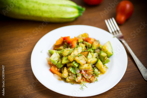 fried zucchini with red pepper, onions, tomatoes and other vegetables