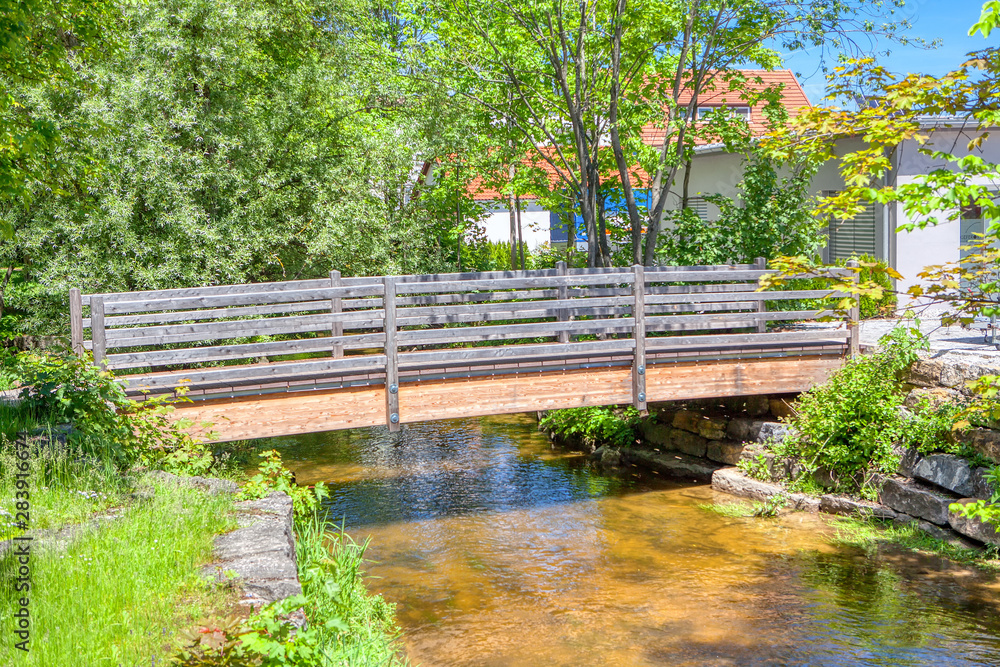 pedestrian wooden bridge over a small river