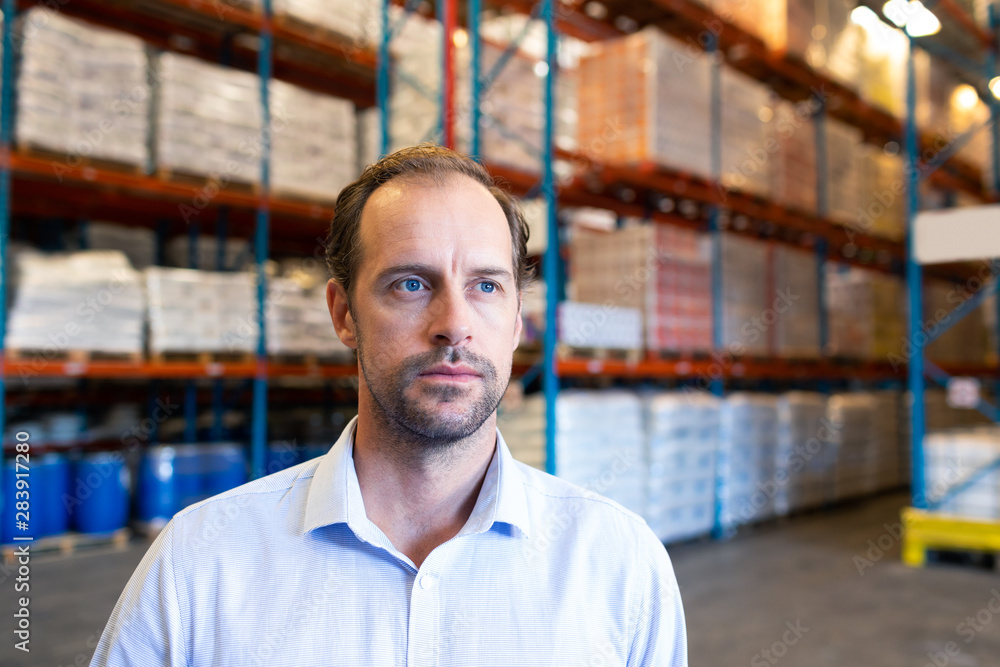 Fototapeta premium Male supervisor looking away in warehouse
