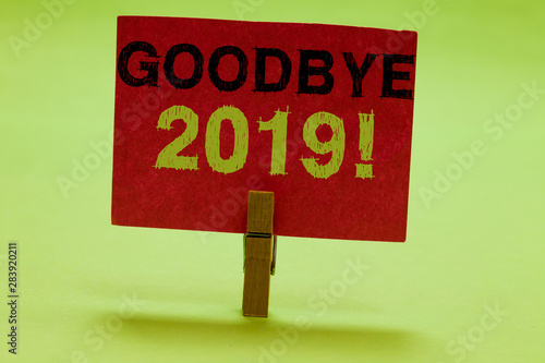 Text sign showing Goodbye 2019. Conceptual photo New Year Eve Milestone Last Month Celebration Transition Clothespin holding red paper important communicating messages ideas photo