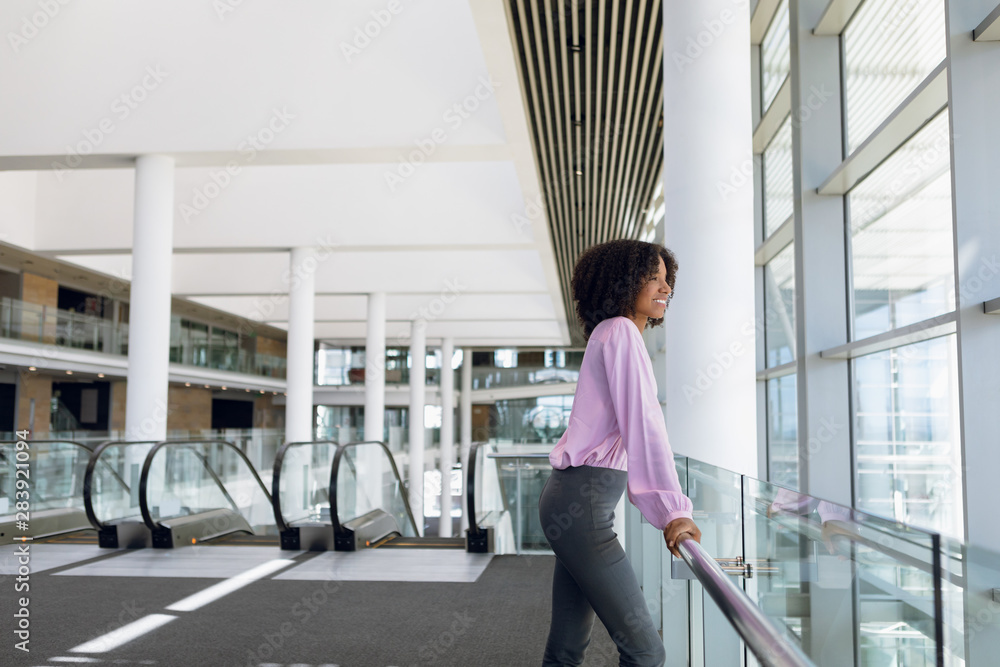 Young businesswoman looking out of window in office Young businesswoman looking out of window in office