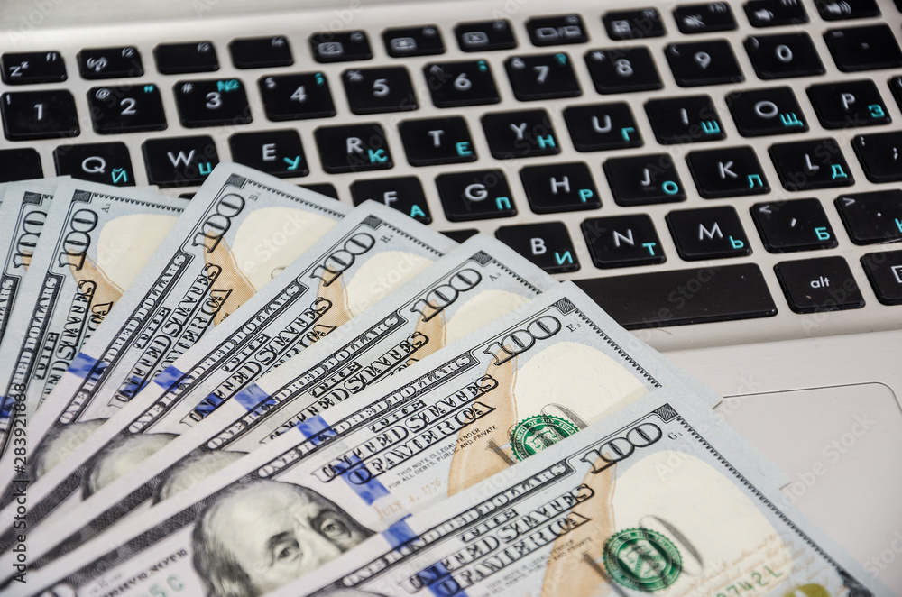 dollars on a laptop keyboard. Close-up dollars on a laptop keyboard. Close-up