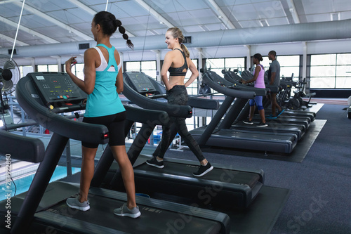 Fit women exercising on treadmill in fitness center