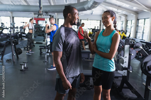 Man and woman interacting with each other in fitness center