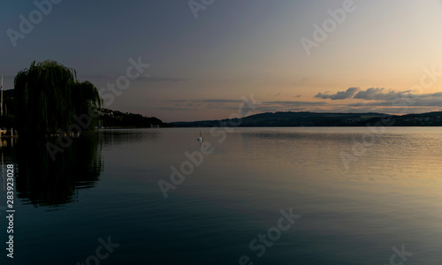 early morning on the lake, the chair, the silhouettes of the mountains