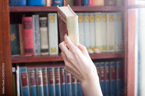 Girl borrow a book from the library