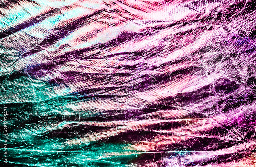 Obraz premium Textured silver foil background with shiny crumpled surface in trendy colors.