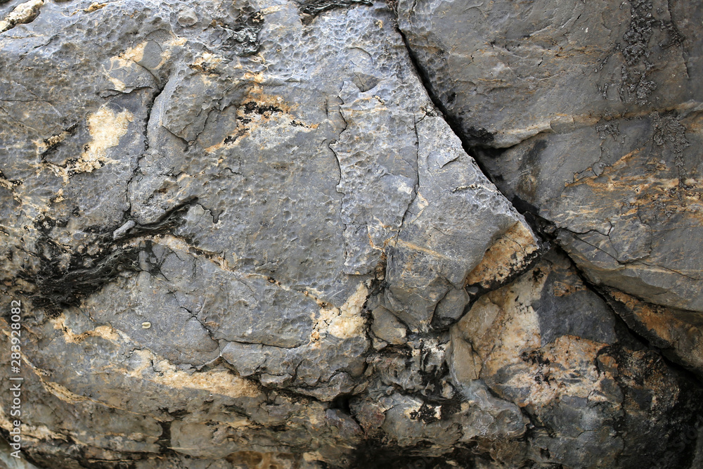 Fototapeta premium Background texture of rough cliff rock wall