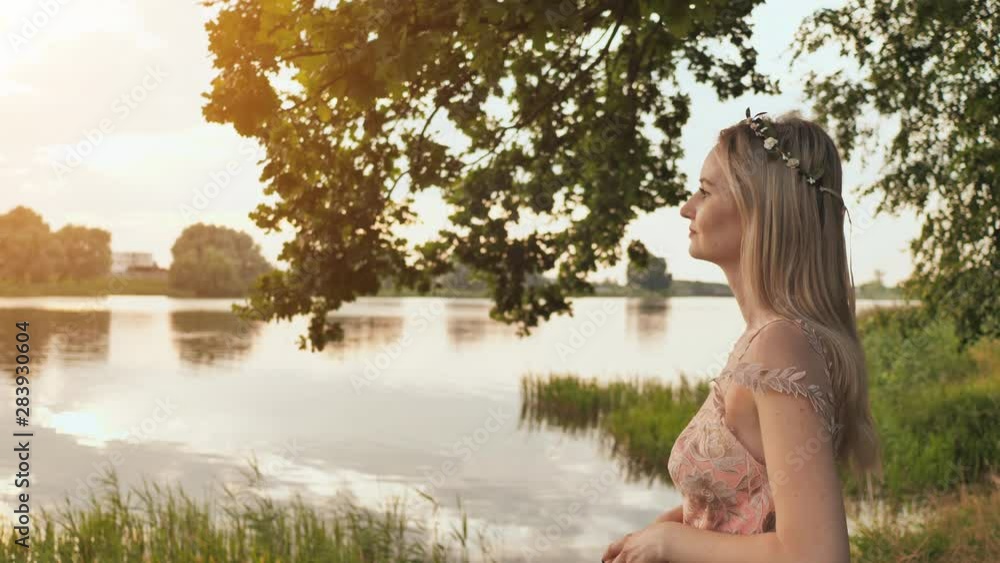 Beautiful young blond woman outdoors portrait near the lake. Beautiful young blond woman outdoors portrait near the lake.