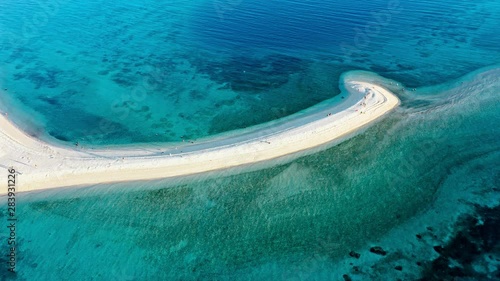 Top down view of tropical sandbar beach with turquoise water and white sand