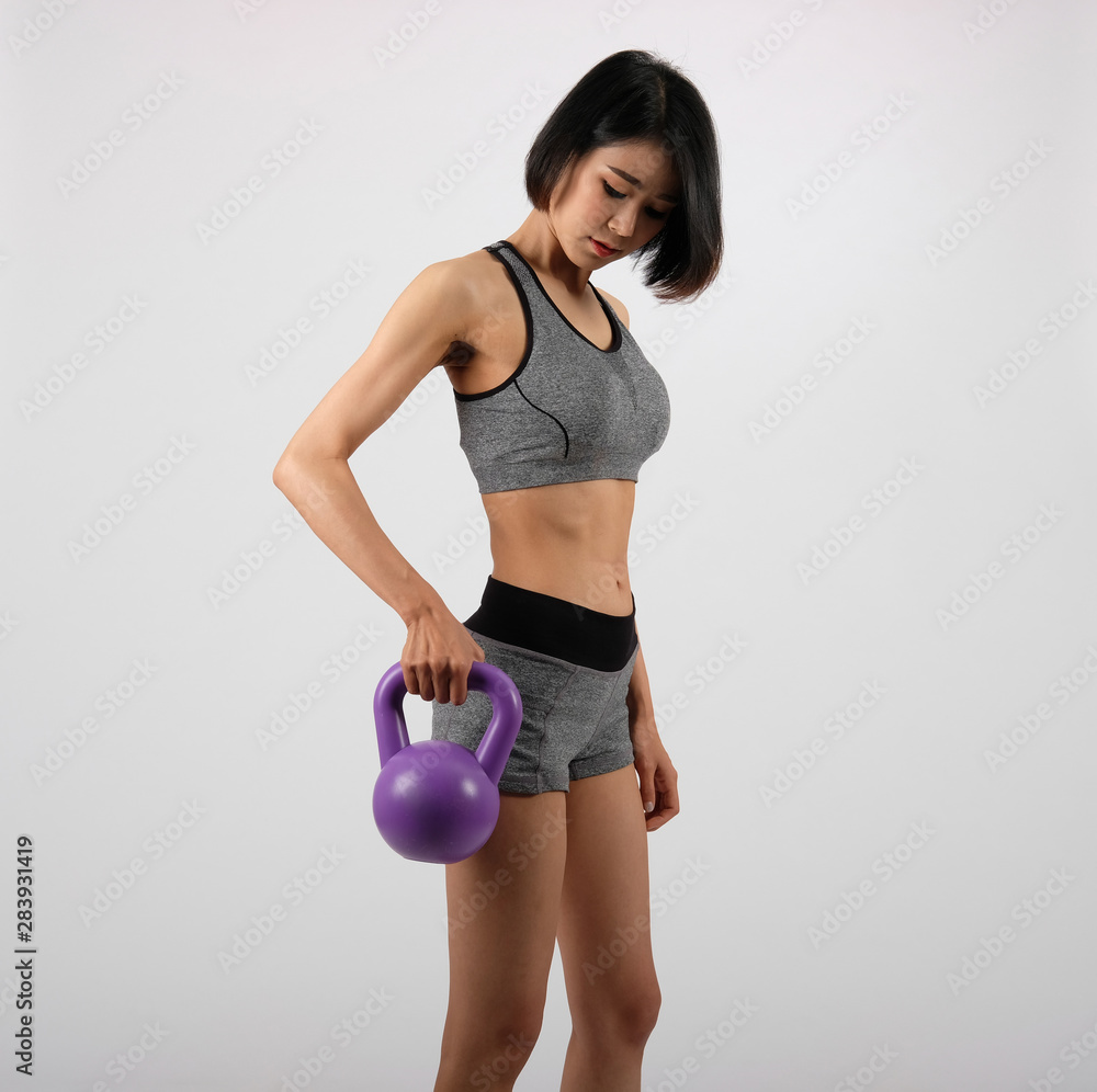 sporty woman in sportswear with kettlebell doing fitness workout on white background. healthy sport lifestyle sporty woman in sportswear with kettlebell doing fitness workout on white background. healthy sport lifestyle