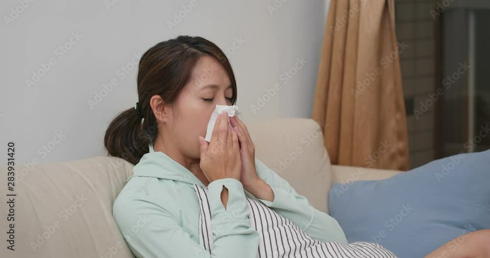 Woman feel sick and sneeze at home Woman feel sick and sneeze at home