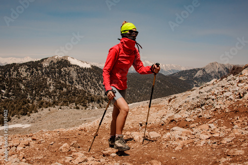 Female tourist with hiking equipment in a mountains
