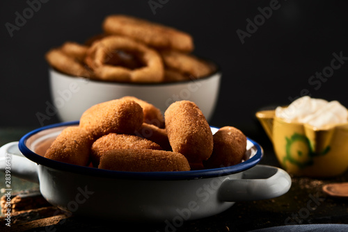 spanish croquettes and fried squid rings photo
