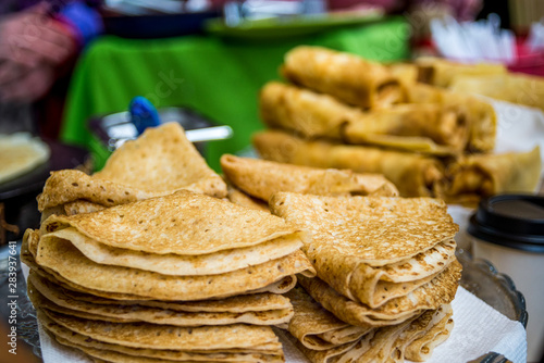 stacks of tasty thin folded pancakes on plate