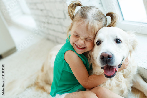 Photography A child with a dog. Girl with a Labrador at home.