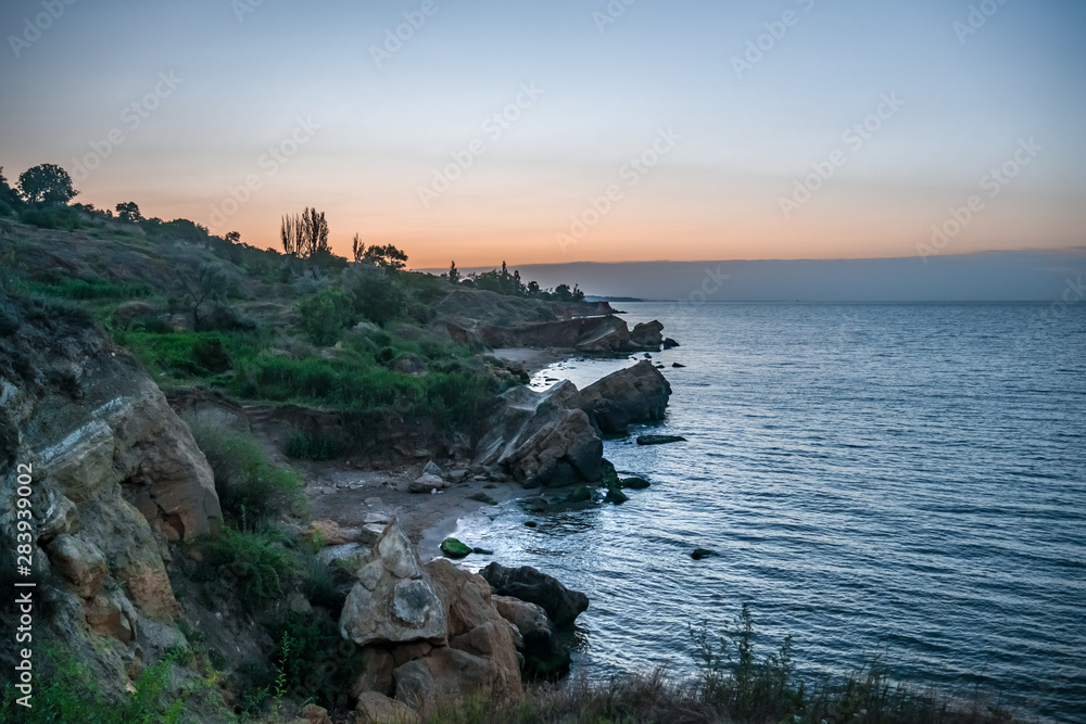 Wild Beach with rocks and trees at the Black Sea a few minutes before dawn