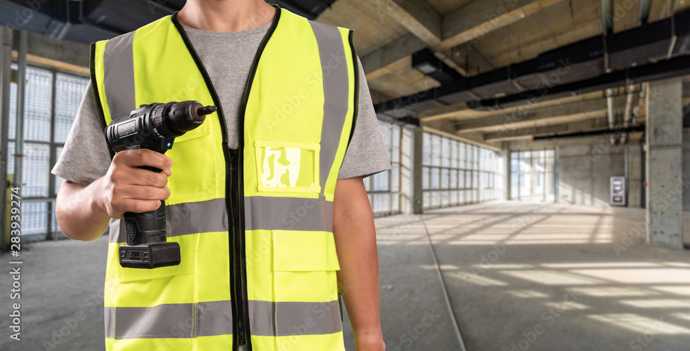 Construction Worker in front of construction site Construction Worker in front of construction site