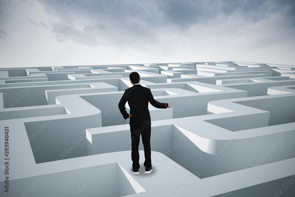 Businessman going straight ahead on a wide road between mazes Businessman going straight ahead on a wide road between mazes
