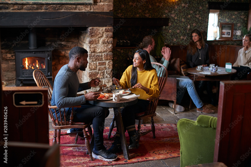 Couple At Table In Traditional English Pub Eating Breakfast Couple At Table In Traditional English Pub Eating Breakfast