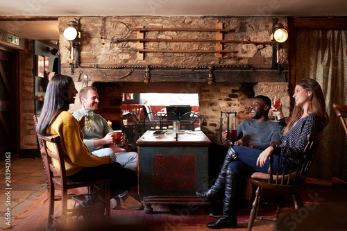 Group Of Friends Meeting For Lunchtime Drinks In Traditional English Pub © Monkey Business